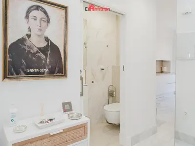 a bathroom with a portrait of a woman on the wall at DUPLEX NUEVO CONVENTO PLAZA CABILDO in Sanlúcar de Barrameda