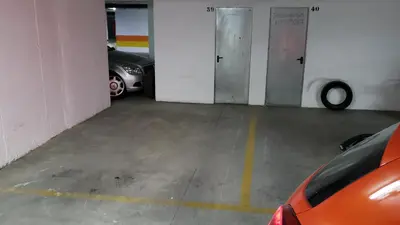 a garage with two cars parked in it at Apartamento Las Infantas. Centro de Sanlucar. in Sanlúcar de Barrameda