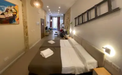 a bedroom with a large bed in a room at GADEIRAS SUITES - Apartamentos Turísticos de 2 llaves in Cádiz