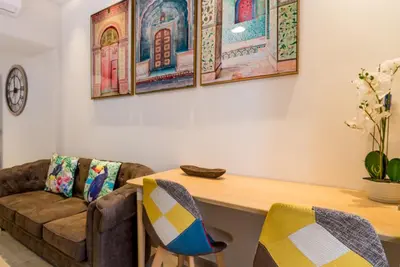 a living room with a couch and a wooden table at Suite Capitán 3 in Cádiz