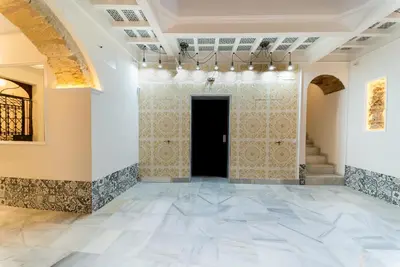 an empty room with a door and a tile floor at Suite Capitán 3 in Cádiz