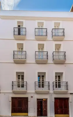 a facade of a white building with balconies at Suite Capitán 3 in Cádiz
