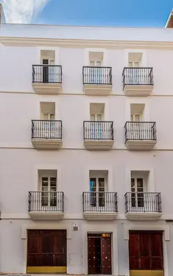 a facade of a white building with balconies at Suite Capitán 1 in Cádiz