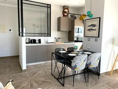 a kitchen with a dining table and chairs in a room at Skyline - Penthouse with 50m2 private terrace and stunning views in Cádiz