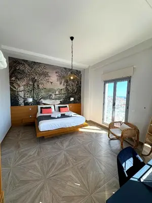 a bedroom with a bed and a painting on the wall at Skyline - Penthouse with 50m2 private terrace and stunning views in Cádiz