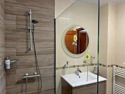 a bathroom with a shower with a sink and a mirror at Apartamento Esencia - Ole Solutions in Arcos de la Frontera