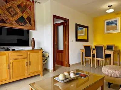 a living room with a television and a table at Apartamento Esencia - Ole Solutions in Arcos de la Frontera