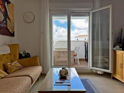 a living room with a couch and a glass table at Apartamento Esencia - Ole Solutions in Arcos de la Frontera