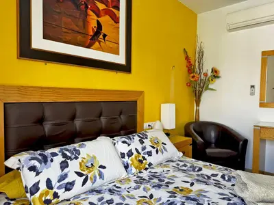 a bedroom with a bed and a painting on the wall at Apartamento Esencia - Ole Solutions in Arcos de la Frontera