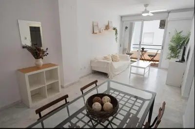 a living room with a glass table and a living room at GINVA - Apartamento con terraza en la ribera del río in El Puerto de Santa María