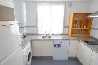 a kitchen with a sink and a washing machine at GINVA - Apartamento con terraza en la ribera del río in El Puerto de Santa María
