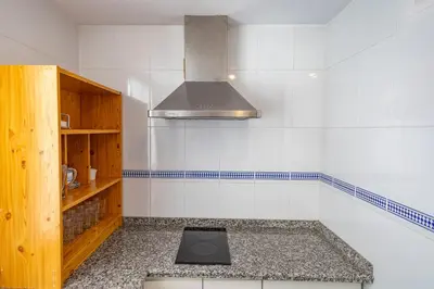 a kitchen with a sink and a stove at GINVA - Apartamento con terraza en la ribera del río in El Puerto de Santa María