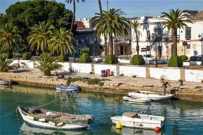 a group of boats docked in a body of water at GINVA - Apartamento con terraza en la ribera del río in El Puerto de Santa María