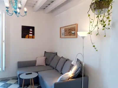 a living room with a couch and a table at Apartamento Puerta al Mar in Cádiz