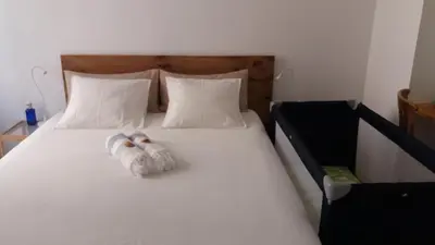 two towels are sitting on a white bed at Los Balcones de Cádiz in Cádiz