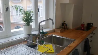 a kitchen counter with a sink and a window at Los Balcones de Cádiz in Cádiz