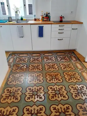 a kitchen with a patterned rug on a kitchen floor at Los Balcones de Cádiz in Cádiz