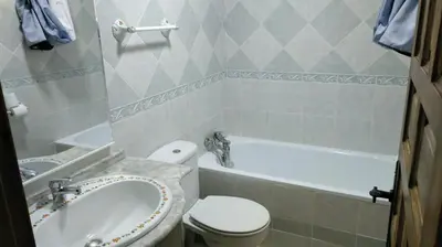 a bathroom with a tub and a toilet and a sink at Junto al Mar in Chiclana de la Frontera