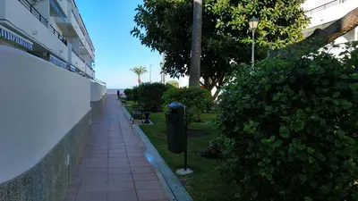 a sidewalk with a parking meter next to a building at Junto al Mar in Chiclana de la Frontera