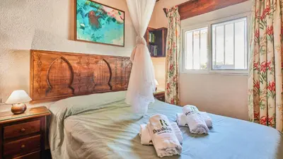 a bedroom with two slippers on a bed at Villa Maymonis Chiclana de la Frontera by Ruralidays in Chiclana de la Frontera