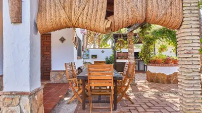 a table and chairs under an umbrella on a patio at Villa Maymonis Chiclana de la Frontera by Ruralidays in Chiclana de la Frontera