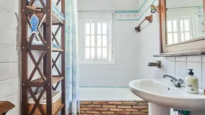 a bathroom with a bath tub and a sink at Villa Maymonis Chiclana de la Frontera by Ruralidays in Chiclana de la Frontera