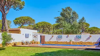 a white house with a fence and a yard at Villa Maymonis Chiclana de la Frontera by Ruralidays in Chiclana de la Frontera