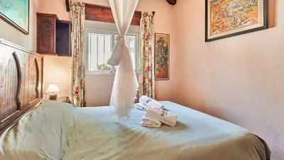 a bedroom with a bed with two towels and a window at Villa Maymonis Chiclana de la Frontera by Ruralidays in Chiclana de la Frontera
