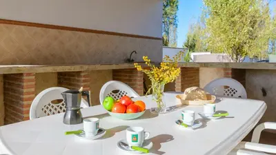 a white table with a bowl of fruit on a patio at Casa San Nicolas Algar by Ruralidays in Algar