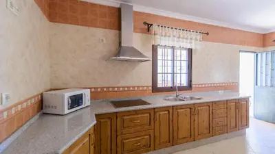 a kitchen with a sink and a microwave at Casa San Nicolas Algar by Ruralidays in Algar