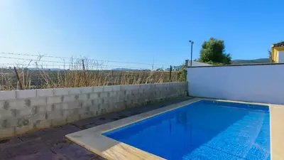 a swimming pool on the side of a house at Casa San Nicolas Algar by Ruralidays in Algar