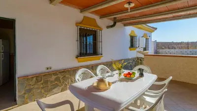 a white table and chairs on a balcony at Casa San Nicolas Algar by Ruralidays in Algar
