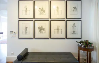 a room with four framed drawings on a wall at Casa Hernán in Cádiz