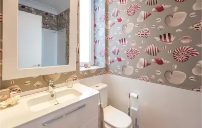 a bathroom with a toilet and a sink and a mirror at Casa Hernán in Cádiz