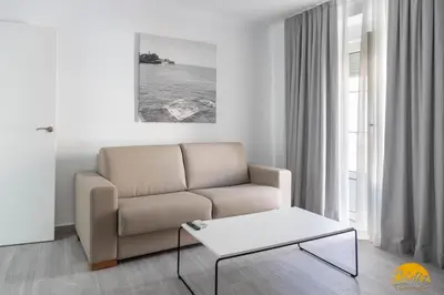 a living room with a couch and a coffee table at The House of Colors by Cadiz Time in Cádiz