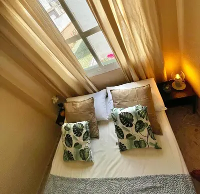 a bed in a small room with a window at GATU Villa Palma, aire acc y confort en el centro histórico, 