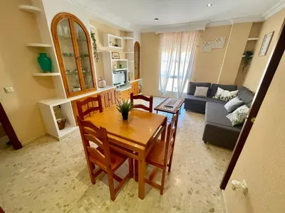 a living room with a table and chairs and a couch at GATU Villa Palma, aire acc y confort en el centro histórico, 