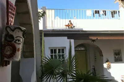 a dog sitting on the balcony of a house at Casa Florinda #7 in Jerez de la Frontera