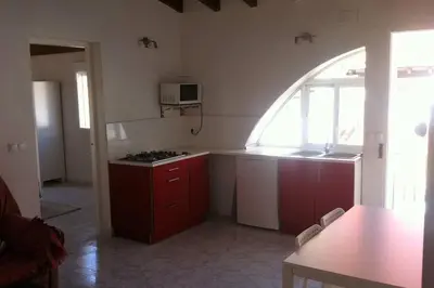 a kitchen with an arched window and a stove top oven at Casa Florinda #7 in Jerez de la Frontera