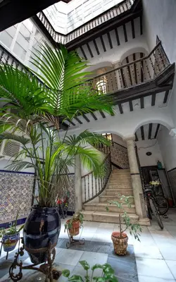 a building with a large vase with plants in it at Casa Maroca in Cádiz