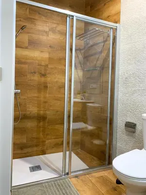 a shower with a glass door in a bathroom at apartamentos la reina in Arcos de la Frontera