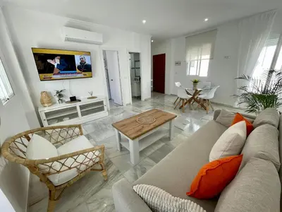 a living room with a couch and a table at apartamentos la reina in Arcos de la Frontera