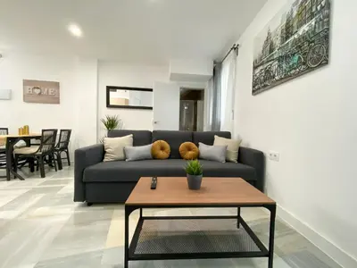 a living room with a couch and a table at apartamentos la reina in Arcos de la Frontera