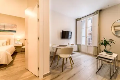 a bedroom with a bed and a desk and a table at Fabio Catedral I in Cádiz
