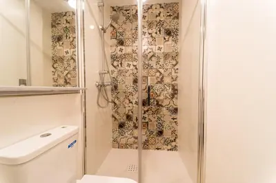 a shower with a glass door next to a toilet at Fabio Catedral I in Cádiz