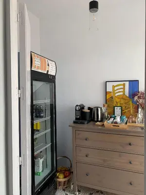 a room with a refrigerator next to a dresser at Casa de las Especias Hotel Boutique in Sanlúcar de Barrameda