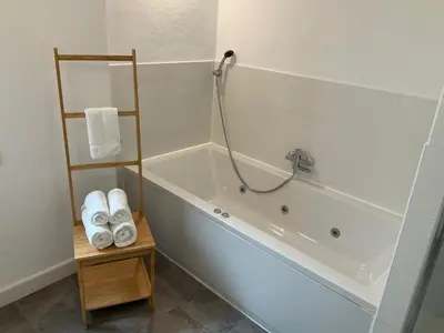 a bathroom with a bath tub with a shower at Casa de las Especias Hotel Boutique in Sanlúcar de Barrameda