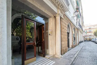 a building with a revolving door on a street at Jardines de Candelaria Cadiz in Cádiz