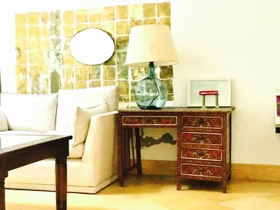 a living room with a couch and a lamp on a table at Casa Bolsa43 in Sanlúcar de Barrameda