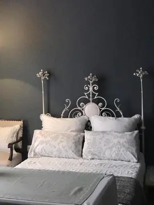 a bedroom with a bed with a metal headboard at Casa Bolsa43 in Sanlúcar de Barrameda